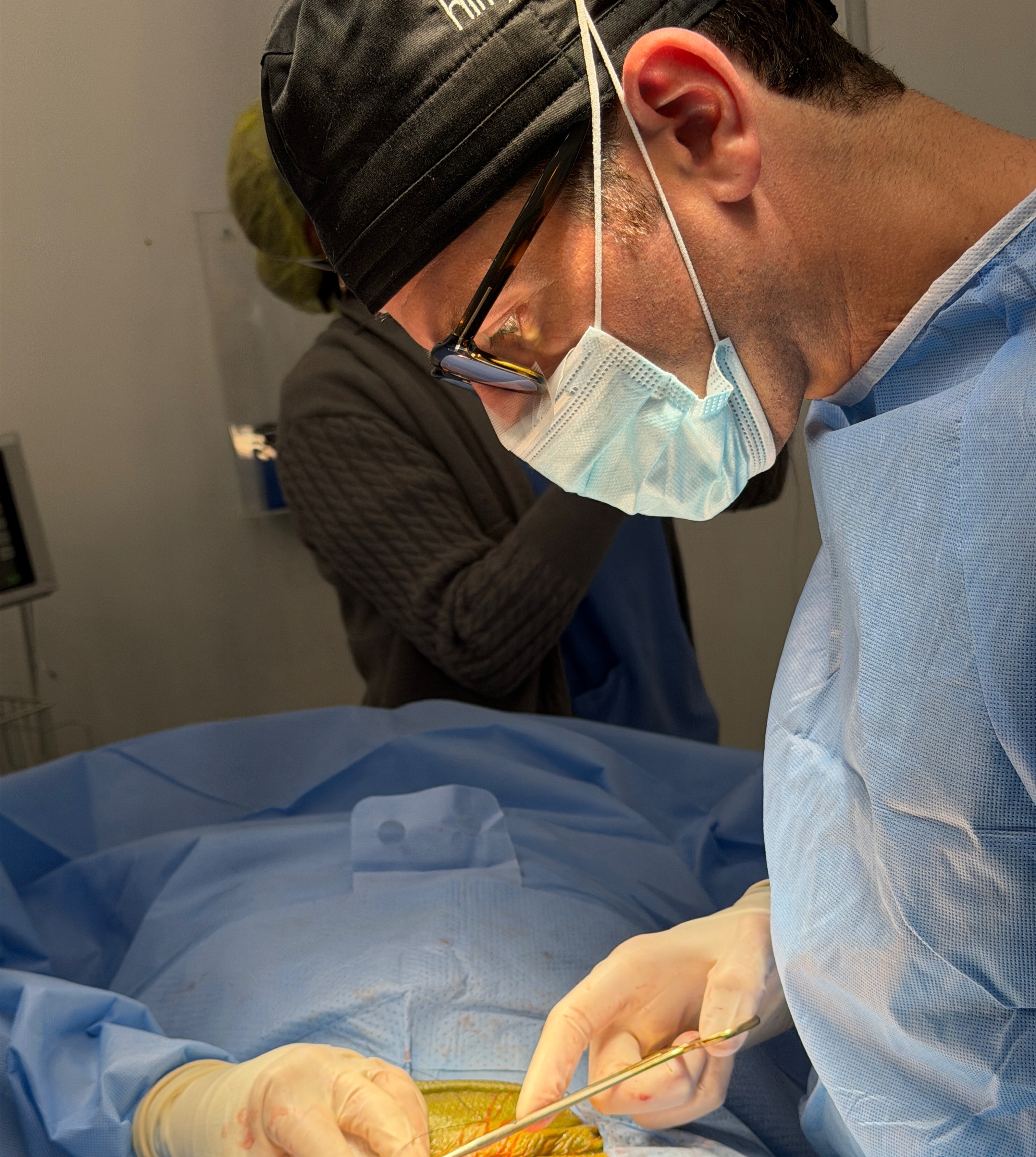 Dr. David Robbins realizando cirugía con precisión meticulosa
